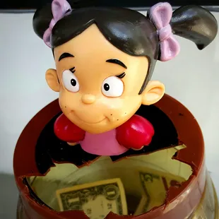a little girl in a barrel of money