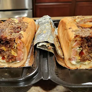 The ribeye steak and cheese sub with lettuce, tomatoes, and grilled onions.