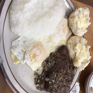 Eggs, grits and liver pudding with aside of biscuits and gravy.