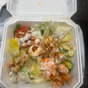 a salad in a styrofoam container