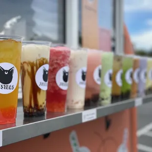 a row of drinks on a shelf