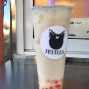 a drink in a plastic cup on a table