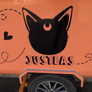 a black cat on an orange food truck