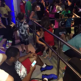 People sitting down while this &quot; new&quot; ride is being fixed.