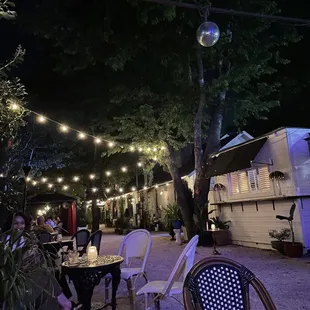 a group of people sitting outside at night