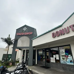 a motorcycle parked in front of a donut shop