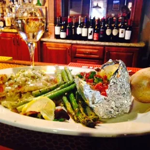 a plate of food and a glass of wine