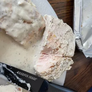 a piece of chicken with gravy and gravy sauce