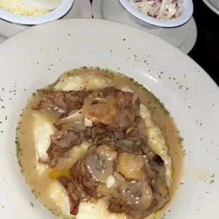 Oxtail on mash, potato salad and coleslaw.