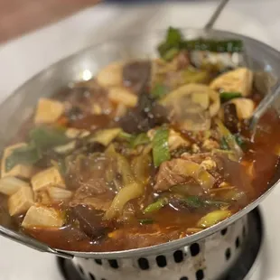 a wok full of food on a stove