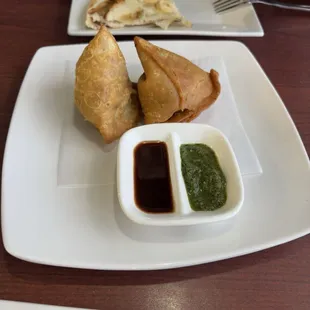 Vegetable Samosa and what&apos;s left of a plain butter Naan