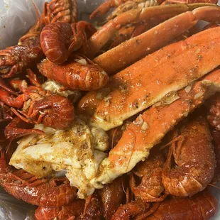 a pile of crab legs and lobsters