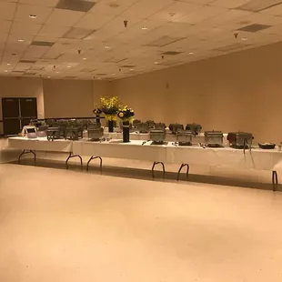 a long table with a variety of food items