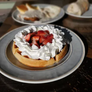 Strawberries and whip on a waffle. Delicious