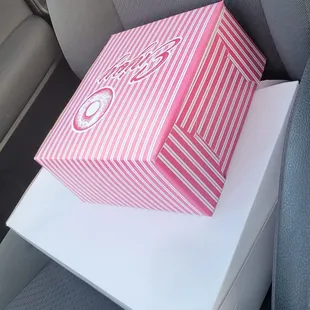 a pink box on a car seat