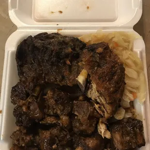 Jerk chicken/Oxtail, Rice and Peas and Cabbage platter.