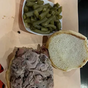 Brisket and pulled pork sandwich with tasty green beans.