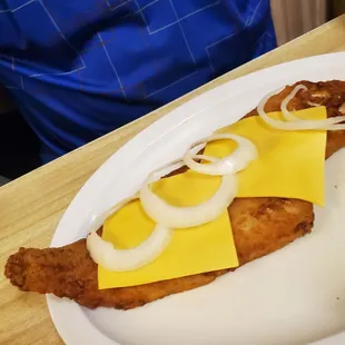 Fish on a dish with cheese and onion