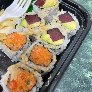a plate of sushi with a fork