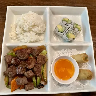 Bento box of hibachi steak, rice, California roll, and spring roll