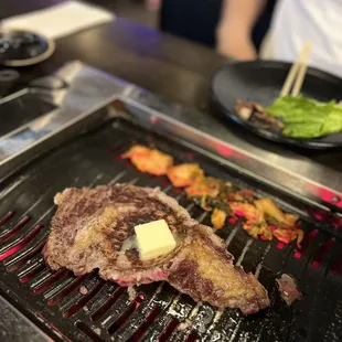 steak with butter on the grill
