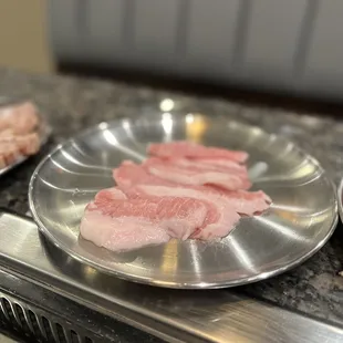 a variety of meats on a grill