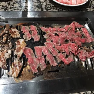 On the left is thick pork belly cooking.  On the right is brisket.