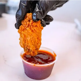 a hand dipping sauce