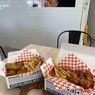 two baskets of fried chicken and french fries