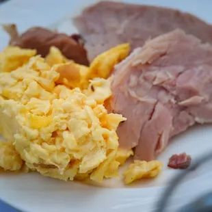 over cooked soggy eggs and ham from carving Station