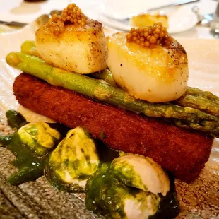 Scallops over polenta cake.
