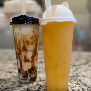 The yellow orange drink was the peach smoothie and it was amazing and the drink with the black top was the tiger milk tea with black boba