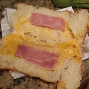 a ham and cheese sandwich on a piece of bread