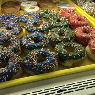 a variety of doughnuts in a display case