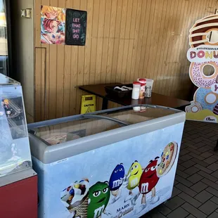 an ice cream stand with a variety of donuts