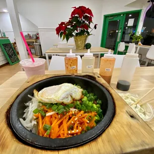 Bibimbap with fried egg, bulgogi and honey chicken.