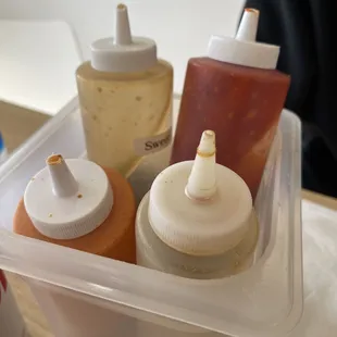 a container of condiments on a table