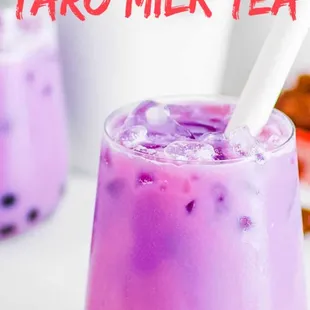 a close up of a glass of taro milk tea