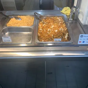 two trays of food on a counter