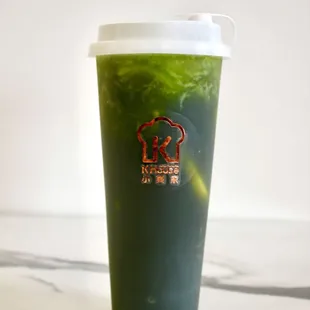 a green drink in a plastic cup
