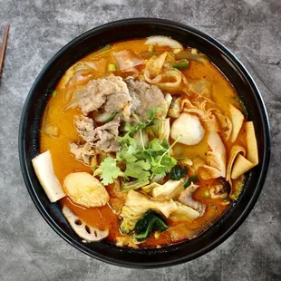 a bowl of soup and chopsticks
