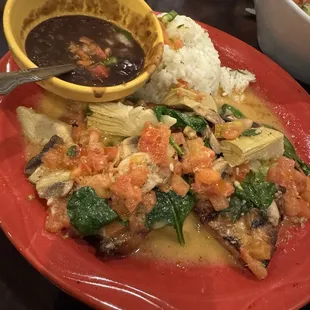 Pollo K-Machos - chicken breast, sautéed mushrooms, artichokes, tomatoes, and lemon wine sauce on spinach. Cilantro white rice, black beans.