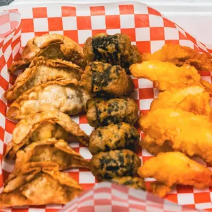 TRIO PLATTER including our dumpling, seaweed roll, and fried crab meat.