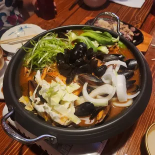 a large bowl of food on a wooden table