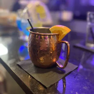a copper mug on a bar