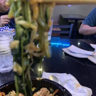 a bowl of food with chopsticks
