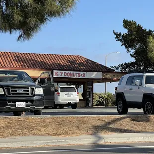 ws a k - t donuts truck parked in front of a k - t donuts store