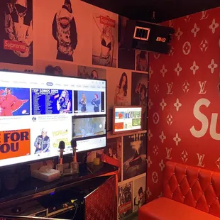 a room with a red couch and a large screen tv