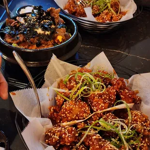 Large boneless with half cluckin hot and half sweet n spicy sauce. Korean beef rice bowl in the middle. They&apos;re huge portions.