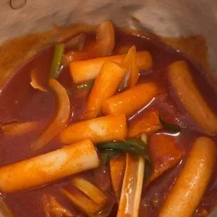 a bowl of stew with carrots